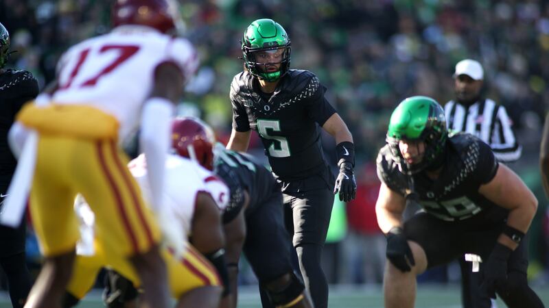 Moore throws 2 TD passes and No. 6 Oregon derails No. 16 USC's CFP hopes with a 42-27 win