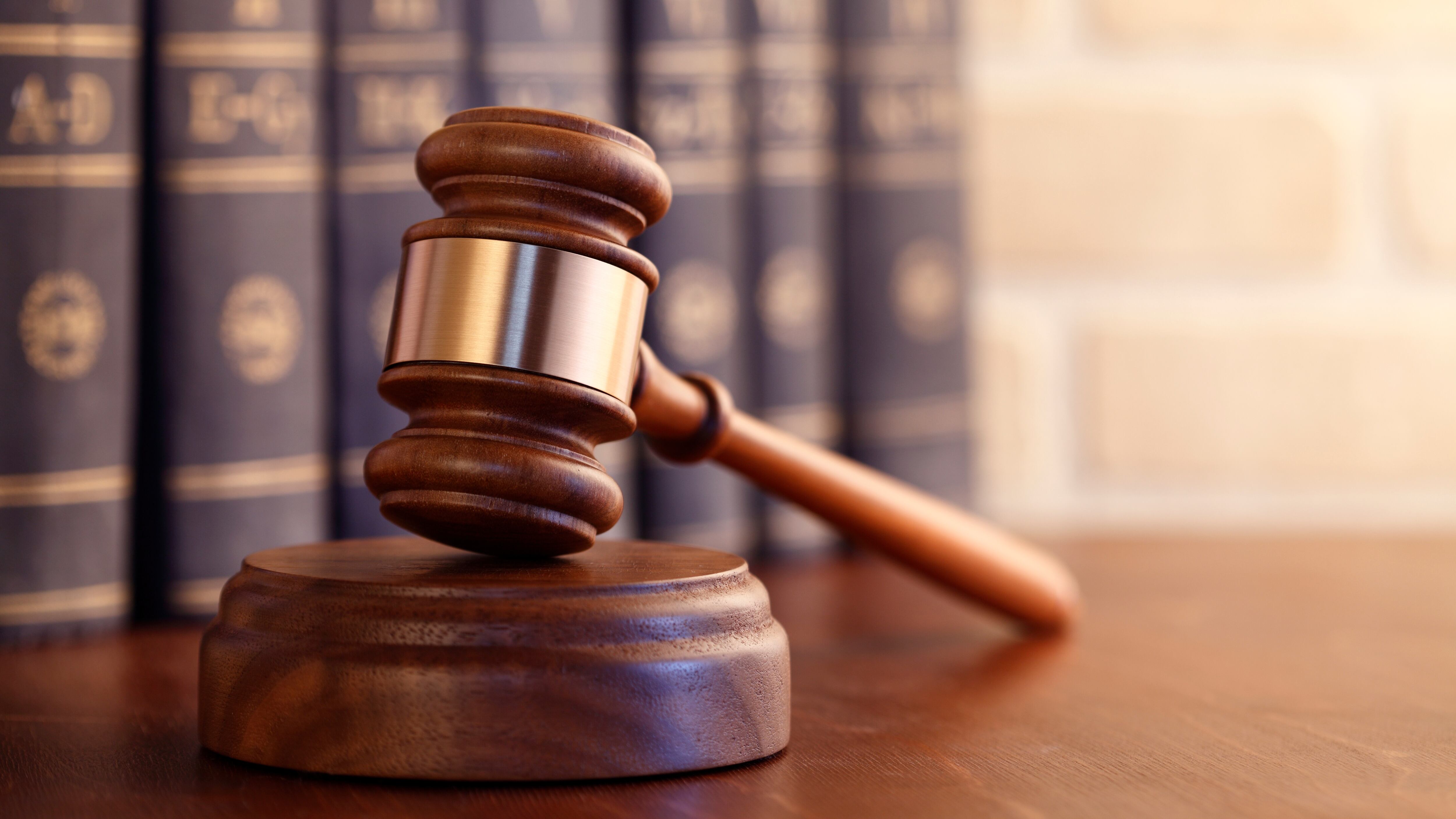 Gavel on a desk in front of law books